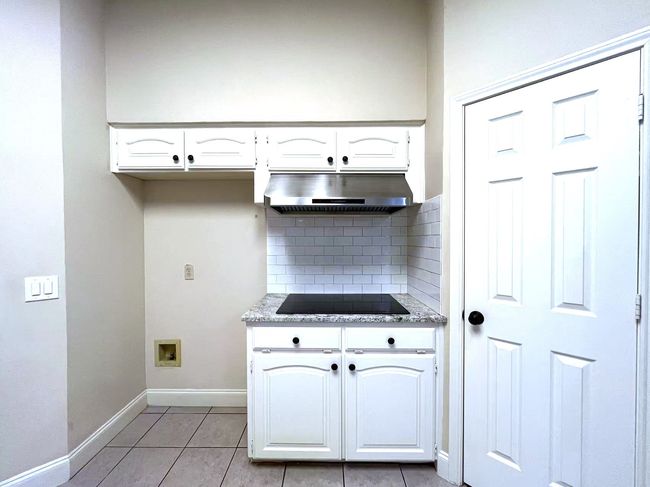 Laundry area featuring baseboards and light tile patterned floors | Image 14