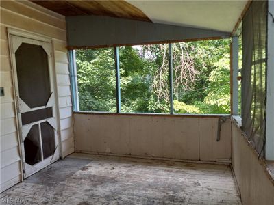 Unfurnished sunroom with vaulted ceiling | Image 3