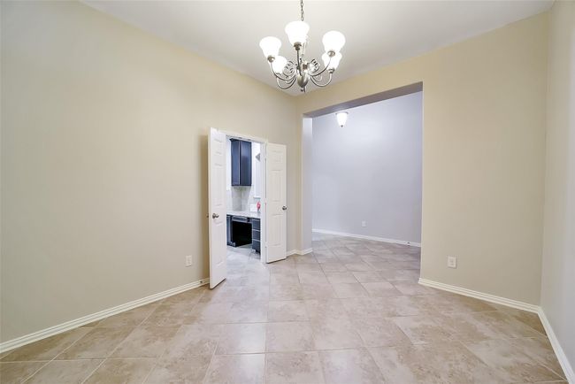 These double doors off the dining room provide easy access to the kitchen and the ability to create an intimate dining experience. | Image 12