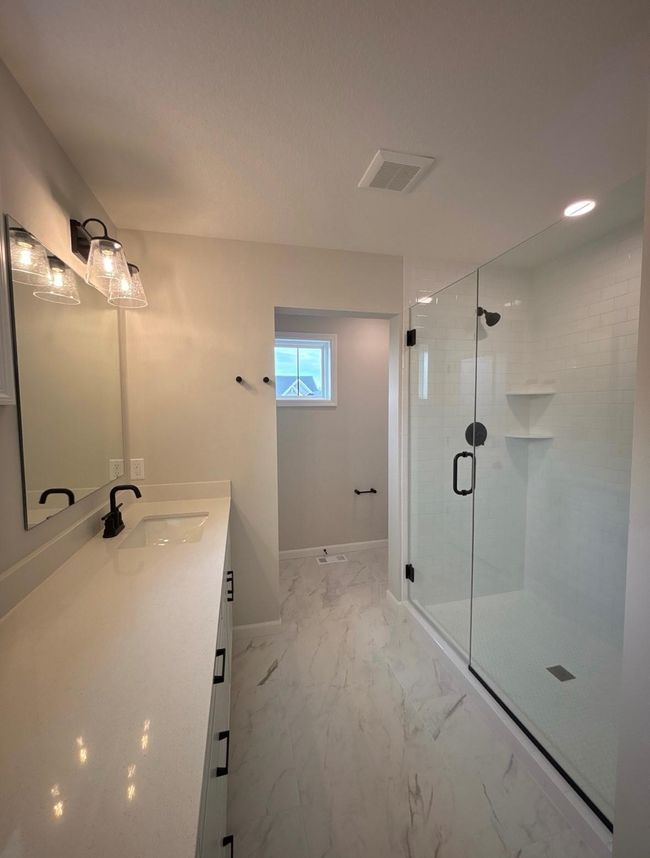 Primary Bath with tiled shower walls to ceiling and heavy glass shower door! | Image 16