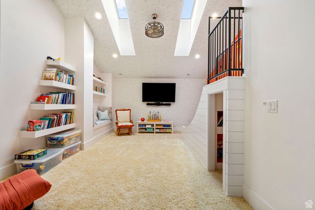 Recreation room with vaulted ceiling with skylight, recessed lighting, and carpet | Image 49