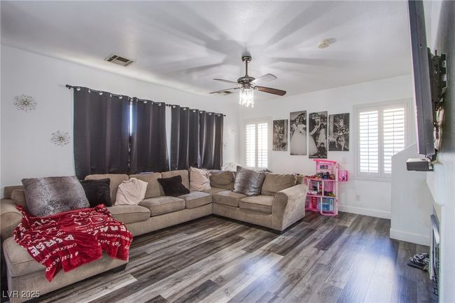 Living room featuring dark wood finished floors, a ceiling fan, and baseboards | Image 8