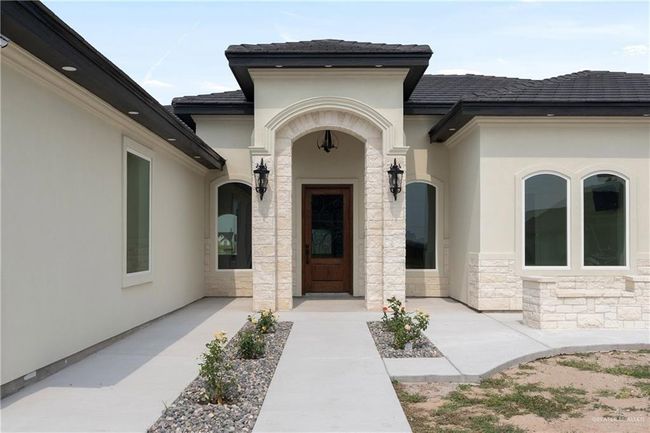 Outdoors, enjoy thoughtfully designed stone-accented sitting areas in the front—perfect for evening sunsets and casual conversations with neighbors. Set on a generous half-acre lot, this home offers space, sophistication, and seamless control at your fingertips or by simple voice command. | Image 4