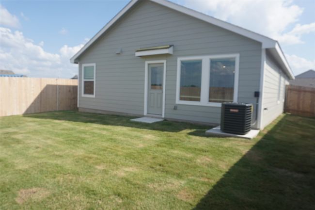 Rear view of property featuring a fenced backyard | Image 17