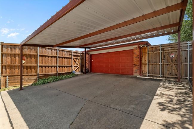 Garage featuring a carport and a gate | Image 33