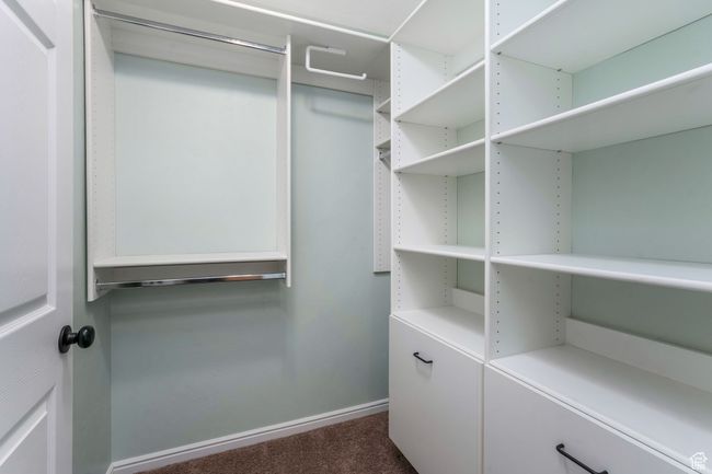 Walk in closet with dark carpet | Image 14