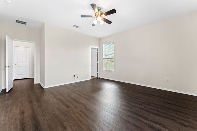 Primary Bedroom featuring ceiling fan and dark wood-type flooring | Image 15