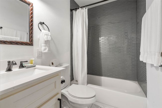 Full bathroom with vanity and shower / bath combo with shower curtain | Image 21
