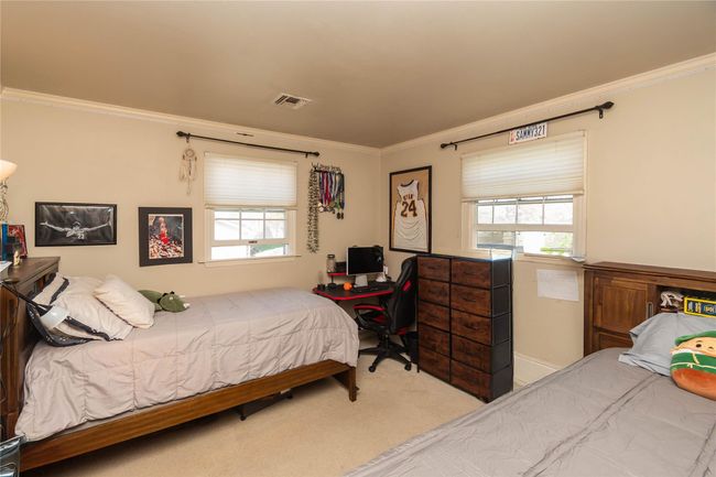 Bedroom with crown molding, multiple windows, visible vents, and carpet | Image 16