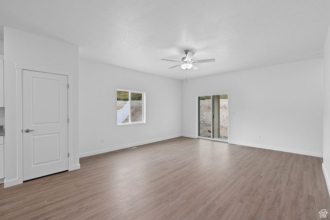 Unfurnished room with a wealth of natural light, a ceiling fan, and wood finished floors | Image 6