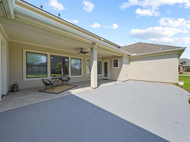 Large Covered Patio with a fan and beautiful view of the huge backyard | Image 46