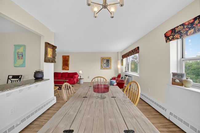 Dining room with a baseboard radiator, a chandelier, and healthy amount of natural light | Image 23