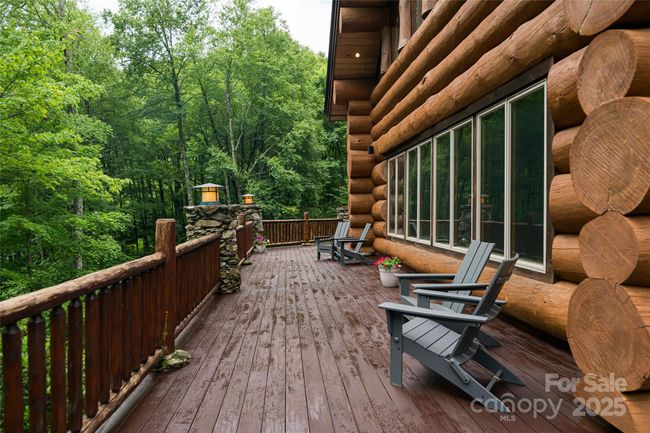 Immense Main level deck offers ample space to enjoy the lush park like setting | Image 38