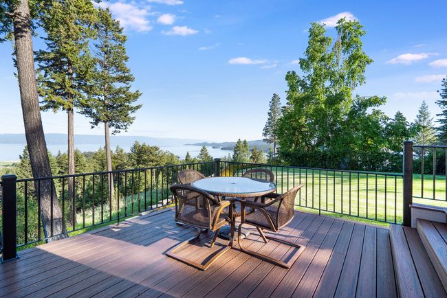 Outdoor deck with well maintained landscaping and views | Image 14