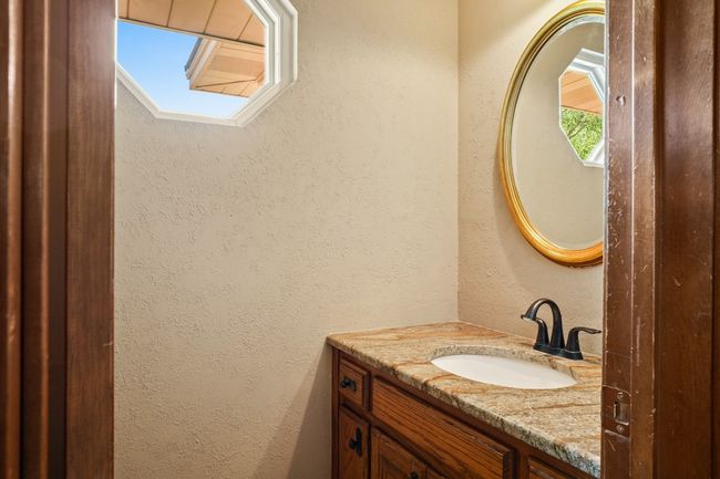 Bathroom with vanity and a textured wall | Image 19