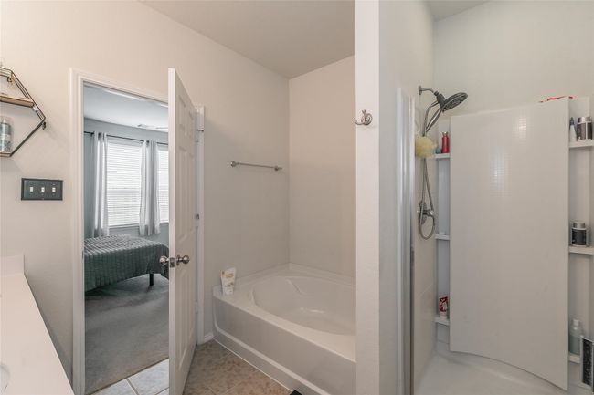 Bathroom featuring separate shower and tub, vanity, and tile patterned floors | Image 32