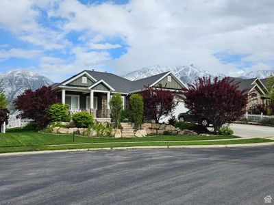 View of front of home with a mountain view, covered porch, and a front lawn | Image 2