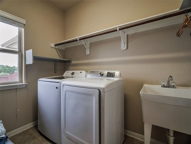 Laundry area with washer and dryer and baseboards | Image 21