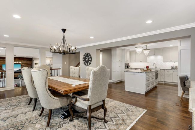 a view showing the dining room as it relates to the kitchen and family room. Beautiful hardwood floors too | Image 14