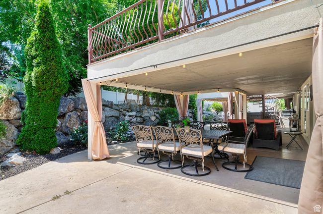 View of patio with outdoor dining area and stairs | Image 52