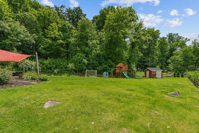 View of green lawn featuring a playground | Image 7