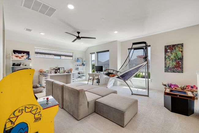Living area with light colored carpet, ceiling fan, and recessed lighting | Image 28