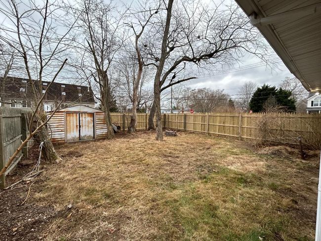 View of yard with a storage shed | Image 4