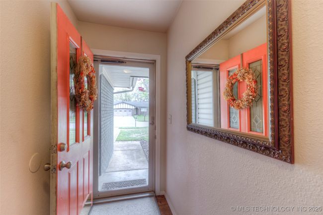 Foyer to greet guests and a storm door to brighten the entryway. | Image 5