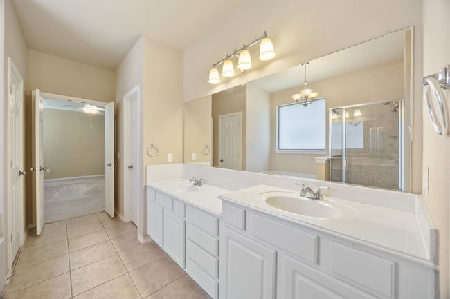 Pampered primary bathroom. His and her closets | Image 17