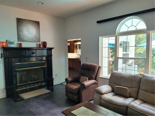 Family room w/ fireplace w/doorway to kitchen | Image 11