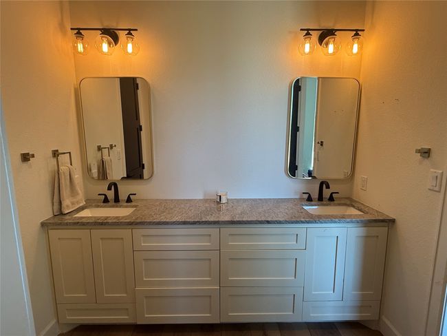 Full bath featuring double vanity and a textured wall | Image 10