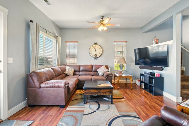 Living area featuring wood finished floors, ceiling fan, and baseboards | Image 9