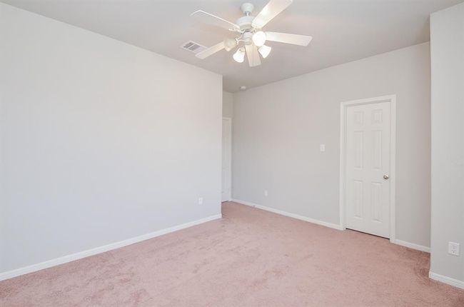 Another secondary bedroom welcomes family and staying guests. | Image 23