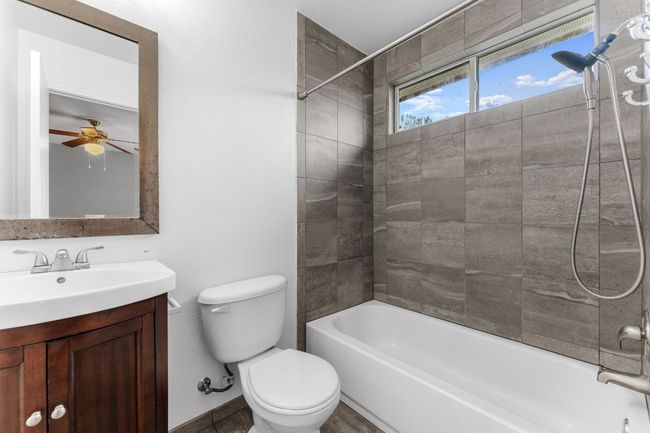 Primary Bathroom featuring vanity, bathtub / shower combination, and a ceiling fan | Image 13