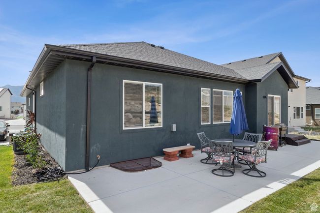 Back of house with roof with shingles, a patio area, and stucco siding | Image 5