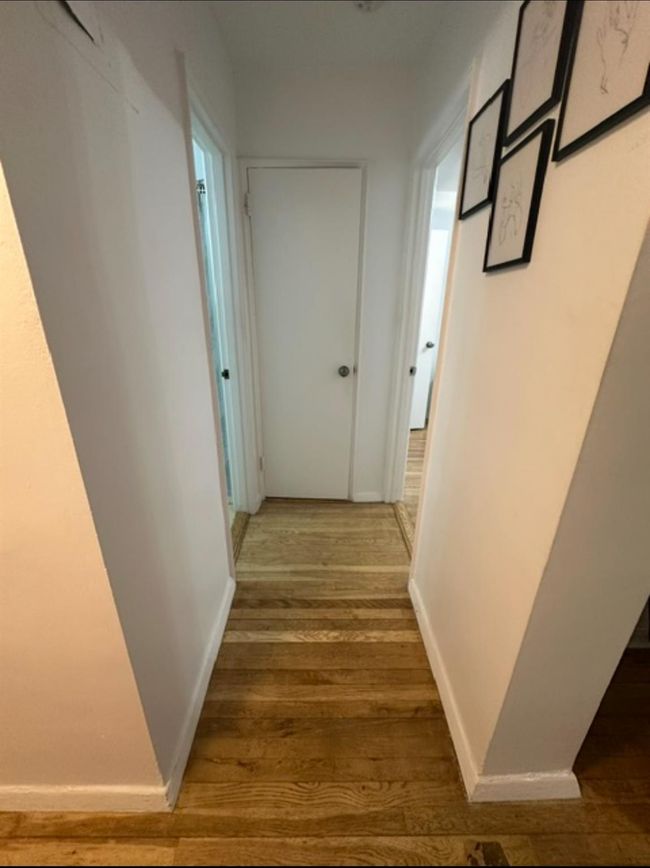 Corridor featuring wood finished floors and baseboards | Image 5