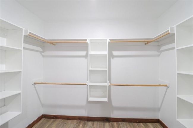 Spacious closet featuring dark hardwood / wood-style flooring | Image 26