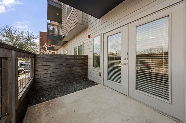 View of patio / terrace with a balcony, fence, and french doors | Image 10
