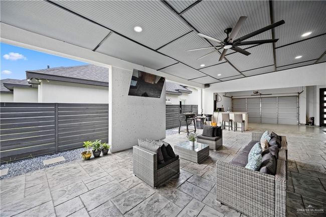 View of patio with ceiling fan, outdoor lounge area, and an outdoor bar | Image 7