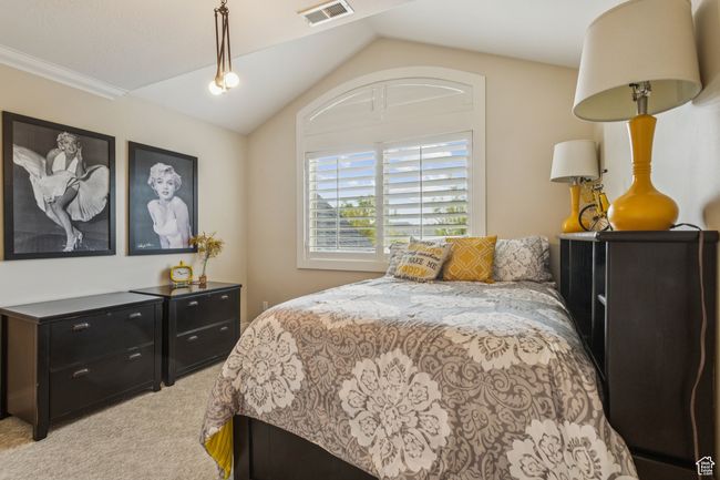 Bedroom featuring light carpet and lofted ceiling | Image 42