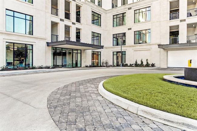 A closer view of the elegant exterior, featuring a large circular driveway and ample parking for your guests | Image 45