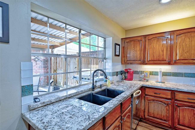 Enjoy a beautiful view of the spacious covered back porch from the kitchen. | Image 12
