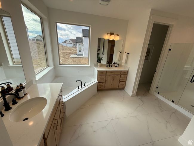 Bathroom with two vanities, a sink, marble finish floor, a shower stall, and a bath | Image 14