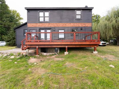 Back of house with a deck and a lawn | Image 3