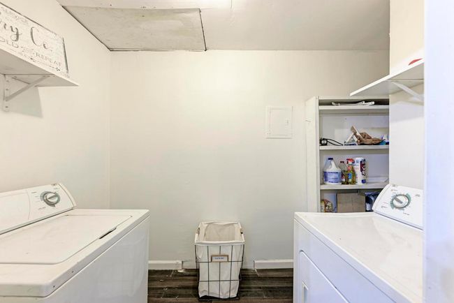Laundry room with washing machine and clothes dryer, laundry area, dark wood-type flooring, and baseboards | Image 26