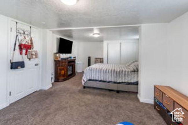 Carpeted bedroom featuring baseboards | Image 18