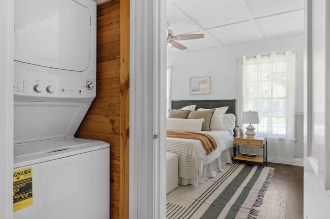 Conveniently located in the hallway between the two bedroooms, you'll love this laundry closet with stacked washer and dryer. | Image 13