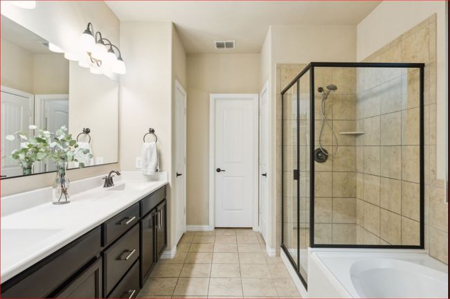 Full bathroom with a stall shower, double vanity, a bath, and tile patterned floors | Image 14