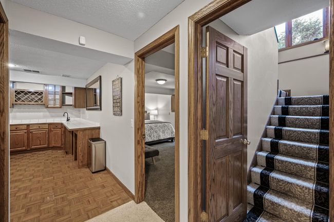 Headed downstairs to 2 more bedrooms and a huge amusement room and walkout lower level | Image 36