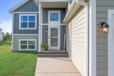 A manicured lawn with lush greenery add to the curb appeal of this home. | Image 2